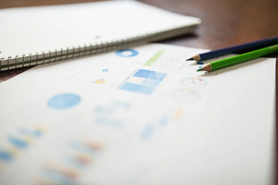 Detailed close-up of a woman working on a digital marketing project in a home office environment.